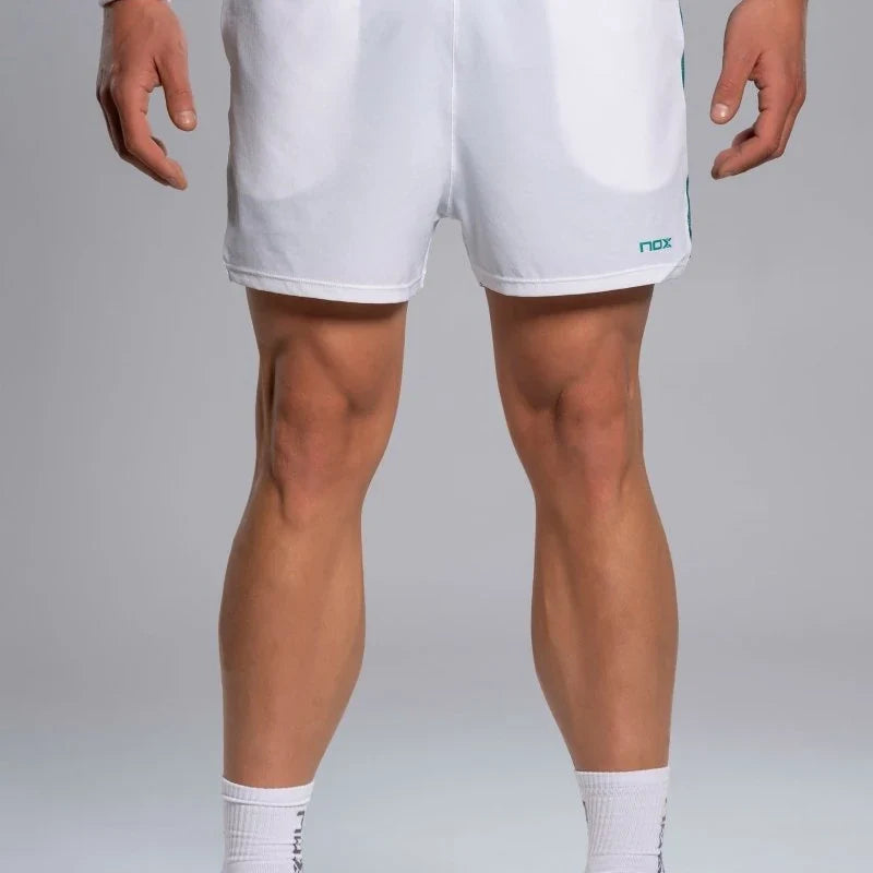 2026 Nox Pro men's padel shorts (White/Ivy Green) - front view on model