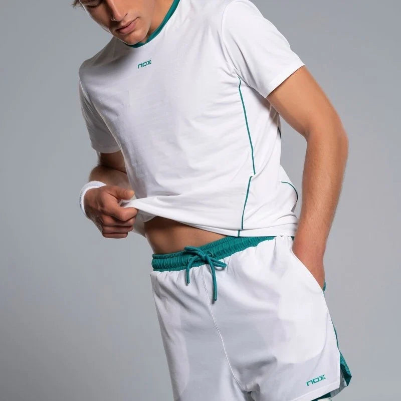 2026 Nox Pro men's padel shorts (White/Ivy Green) - front waistband and drawstring, worn with matching top