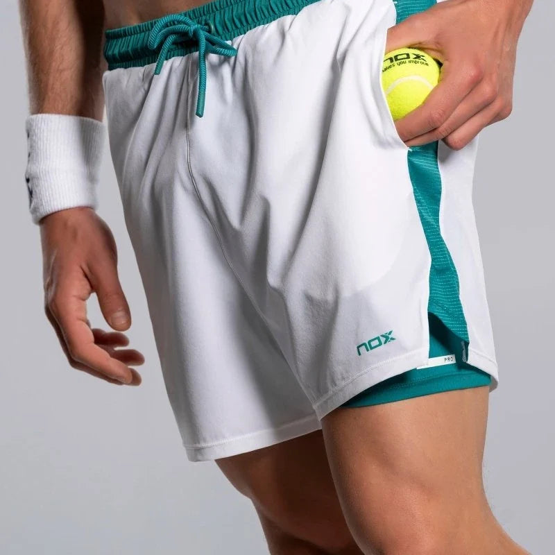 2026 Nox Pro men's padel shorts (White/Ivy Green) - padel ball going into the side pocket