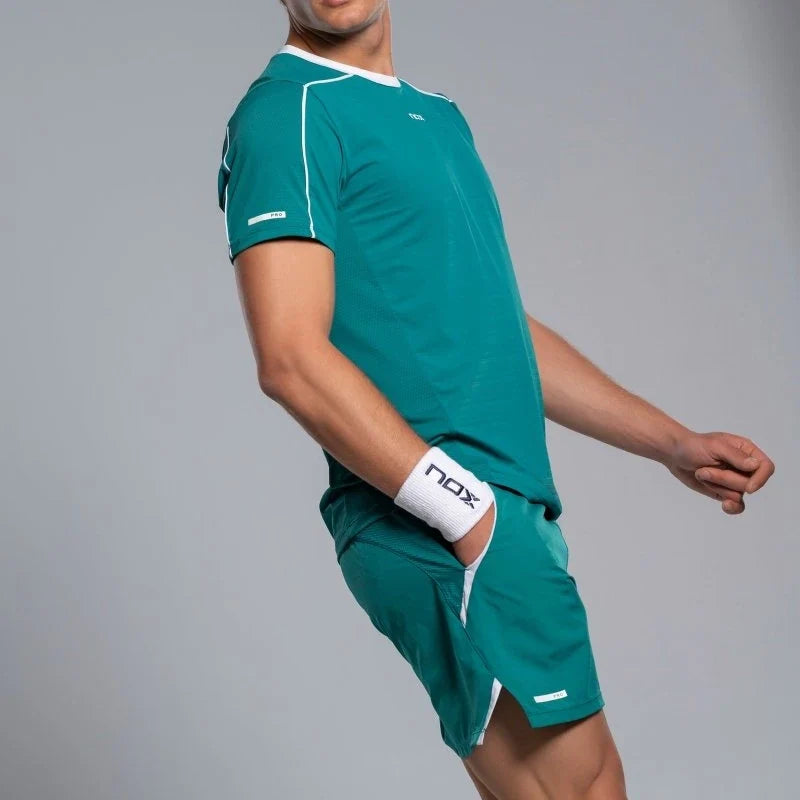 2026 Nox Pro men's padel shorts (Ivy Green) - side view, worn with matching T-shirt
