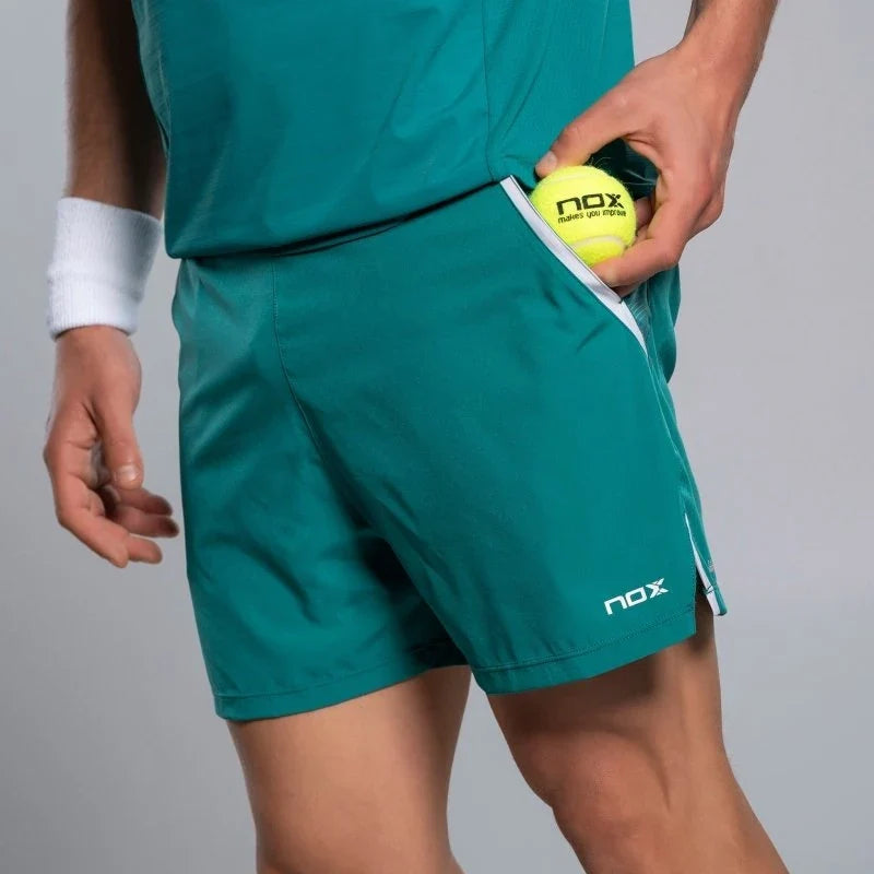 2026 Nox Pro men's padel shorts (Ivy Green) - padel ball going into the side pocket